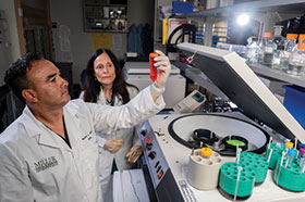 Photo of two scientists in a lab. Links to Donor-Advised Funds
